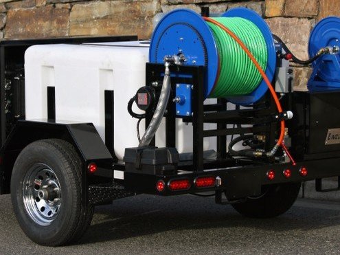 Hydro-jetting trailer with hose reel for clearing drain lines
