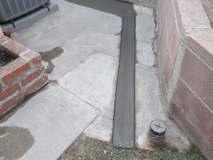 Concrete channel poured along a wall to carry water away