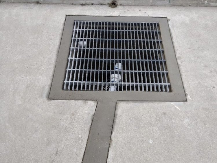 Finished grate drain set into a concrete walkway