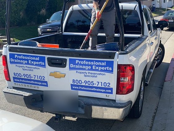 Professional Drainage Experts work truck on site